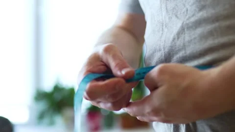 Close Up of Hands Unrolling Measuring Tape 스톡 동영상 340220830