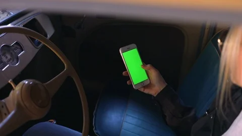 Close up hands use smartphone in vintage car on parking green screen chroma 5g  Stock Footage 112137323