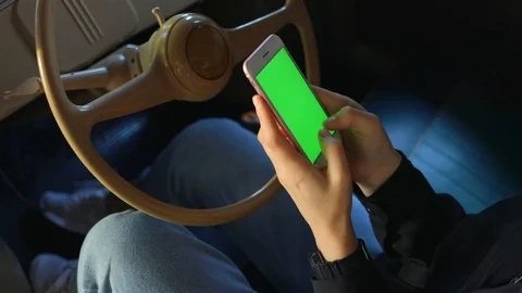 Close up hands use smartphone in vintage car on parking green screen chroma key Stock Footage 112137356