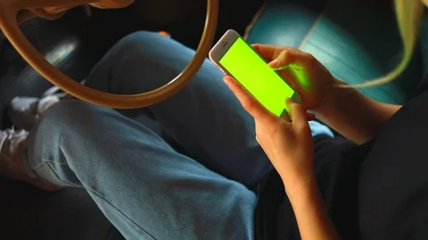 Close up hands use smartphone in vintage car on parking green screen chroma 5g  Stock Footage 112349696