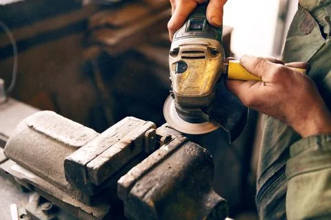 Close-up of hands using an angle grinder Stock Photos