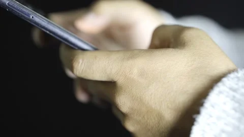 Close up of hands using a cell phone at night, watching social networks Stock Footage 272255028
