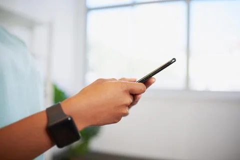 Close up of hands using cellphone, nurse in scrubs with fitness watch Stock Photos