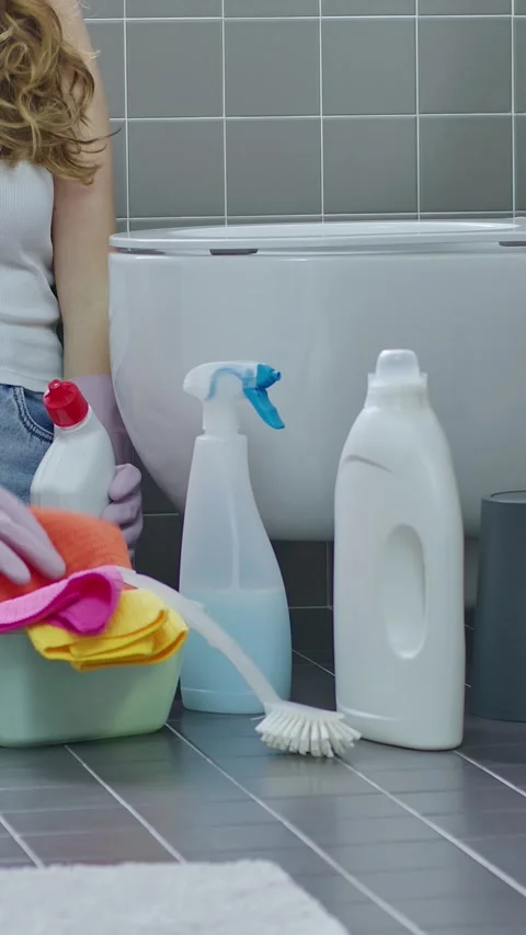 Close Up Hands using a detergent disinfectant bottle and Wiping Toilet Seat Stock Footage 344764326