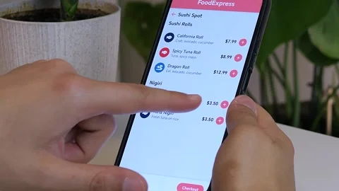 Close-up of hands using a food delivery app to order sushi. Stock-Footage 328494335
