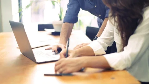 Close up of hands using laptop and writing notes in a notebook Stock Footage 117491435
