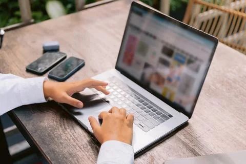 Close up of hands using laptop computer for online work outdoors Stock Photos