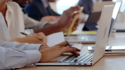 Close Up Of Hands Using Laptop During Meeting Around Table Stock Footage 78912980