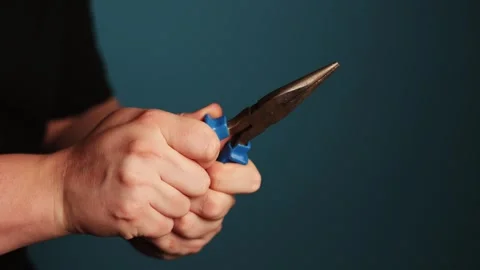 Close-up of hands using long nose pliers for detailed work Stock Footage 340268259