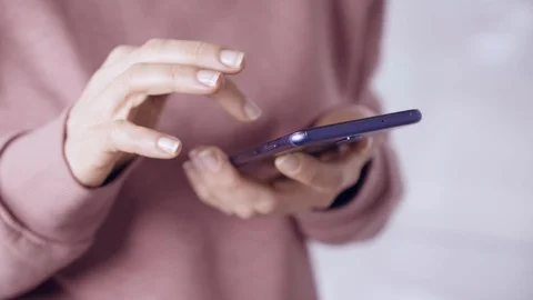 Close-up of hands using a mobile phone scrolling on the screen in social network Stock Footage 123546328