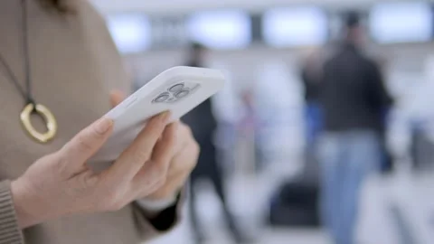 Close-up of hands using mobile phone at airport Stock Footage 340966838
