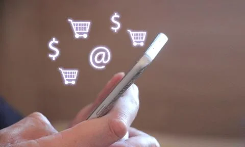 Close up of hands using mobile phone with illuminated light blue icons 库存照片