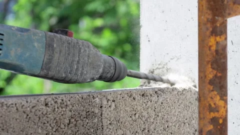 Close-Up of Hands Using Perforator at Construction Site Stock Footage 277875888