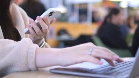 Close-up of hands using phone and laptop Stock Footage 340919086