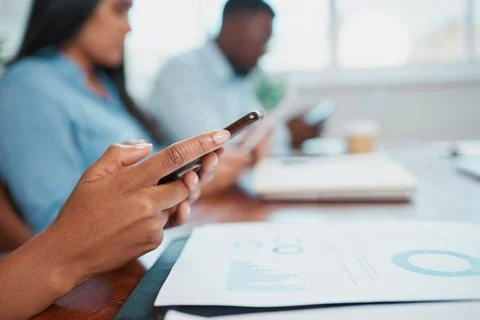 Close up of hands using phone during office meeting, business report Stock Photos
