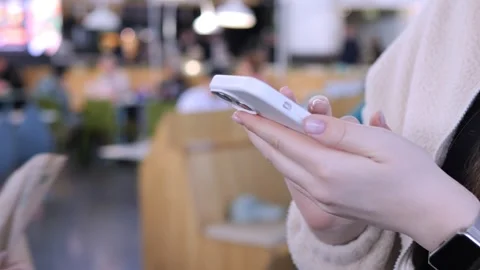 Close-up of hands using phone in public space 스톡 동영상 341074706