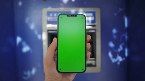 Close up of hands using phone with vertical green screen on ATM background. Stock Footage 222776972