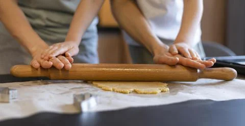Close-up hands using rolling pin Stock Photos