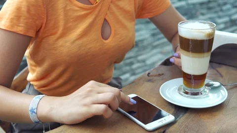 Close up hands using smart phones digital touch screen device while drinking 動画素材 91974162