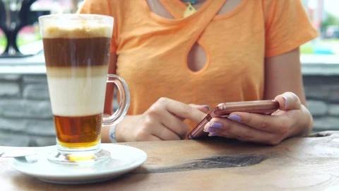 Close up hands using smart phones digital touch screen device while drinking Stock Footage 91974257