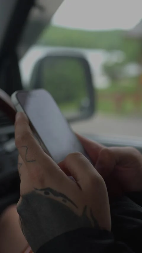 Close-up of hands using a smartphone inside a car, representing... Vídeo Stock 336198335