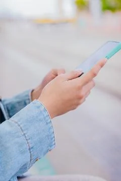 Close-Up of Hands Using Smartphone Outdoors in Urban Setting.Vertical Stock Photos
