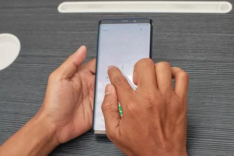 Close Up Of Hands Using A Smartphone With A White Screen And Icons On A Dar.. Stock Photos