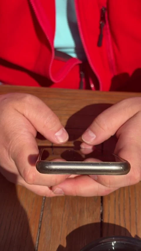 Close up of hands using smartphone at wooden cafe table Video stock 330686508
