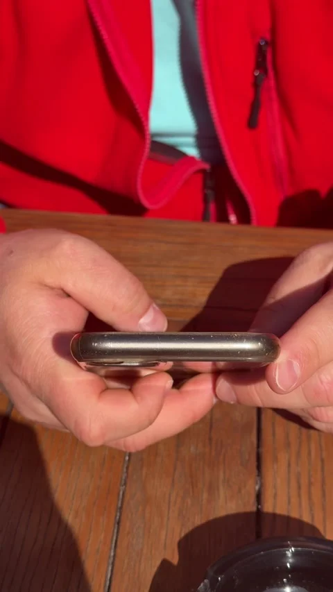 Close up of hands using smartphone at wooden cafe table Stock Footage 330686514