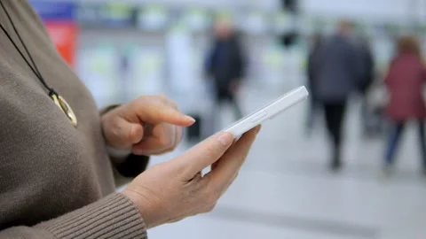 Close-up of hands using tablet amidst crowd Stock Footage 343562667