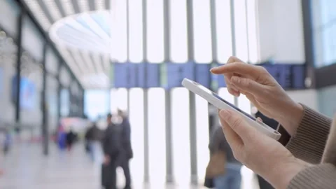 Close-up hands using tablet in busy station Stock Footage 343843416