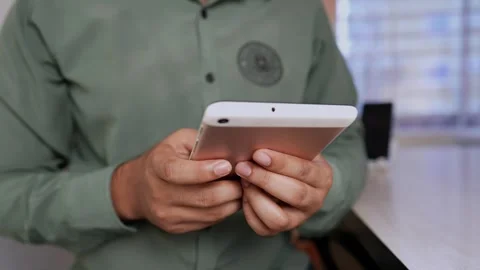 Close-up of Hands Using a Tablet at a Desk, Person using a tablet at a desk.. Stock Footage 317736840