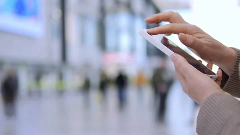 Close-up of hands using tablet in public area Stock Footage 341204149