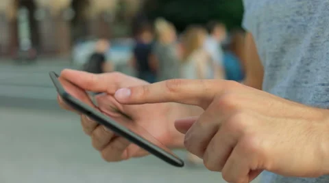 Close up of hands using tablet in the street Stock Footage 68599312