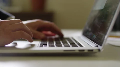 Close up on hands using the trackpad and typing on a laptop Video stock 134266375