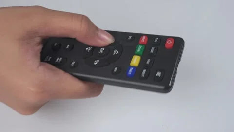 Close up of hands using tv remote isolated white background 库存影片 276727165