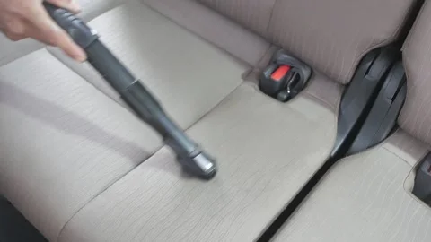 Close up of hands using vacuum cleaner in the car. Man vacuuming vehicle's Stock-Footage 197555235