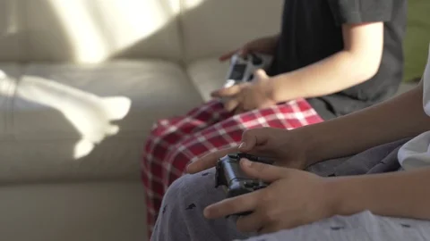 Close-up of hands using a wireless joystick for games on the console at sunny Stock Footage 97742509