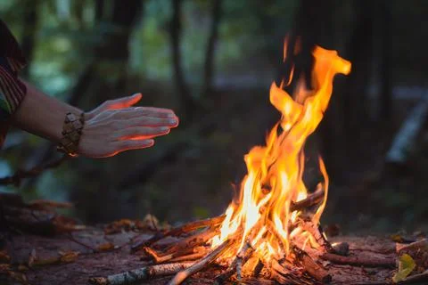 Close up hands warming over campfire concept photo Stock Photos