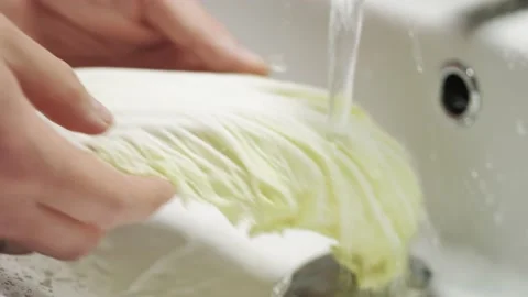 Close-up of hands wash lettuce under running water. Clean and healthy food. Stock Footage 131876435