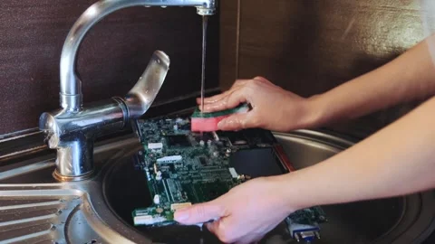 Close-up of Hands Washing Electronic Circuit Board in Kitchen Sink Video stock 342121859