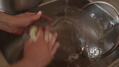 Close up. Hands washing plates with sponge and detergent in sink, housekeeping Stock Footage 152067409