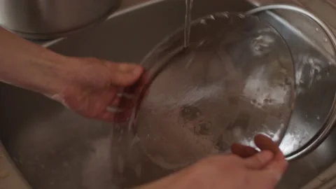 Close up. Hands washing plates with sponge and detergent in sink, housekeeping Stock Footage 152067502