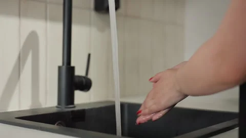 Close up Hands Washing Under Running Water In Modern Kitchen Sink With Red Nails Stock Footage 345077491