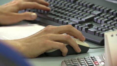 Close up hands of a website designer on their keyboard and mouse Stock Footage 251434632