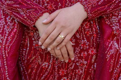 Close-up of Hands with Wedding Ring on Red Dress Stock Photos