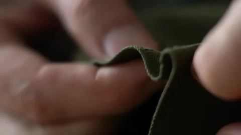 Close-up of hands which carefully sewing thick fabric with needle and thread Stock Footage 275034986