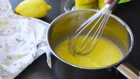Close-up of hands whisking lemon curd in a saucepan 스톡 동영상 344661278