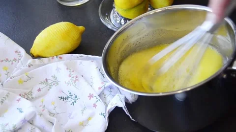 Close-up of hands whisking lemon curd in a saucepan 스톡 동영상 344661386