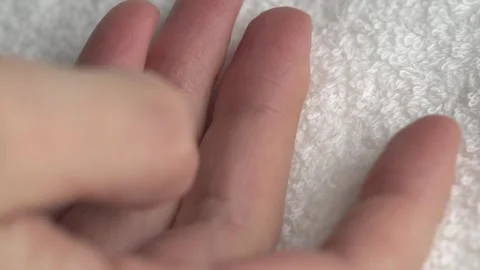 Close-up of hands on white bath towel. Details of a white terry towel. Stock Footage 262417629